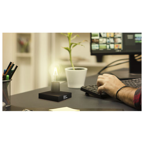 Back view of creative film maker working on a movie on laptop